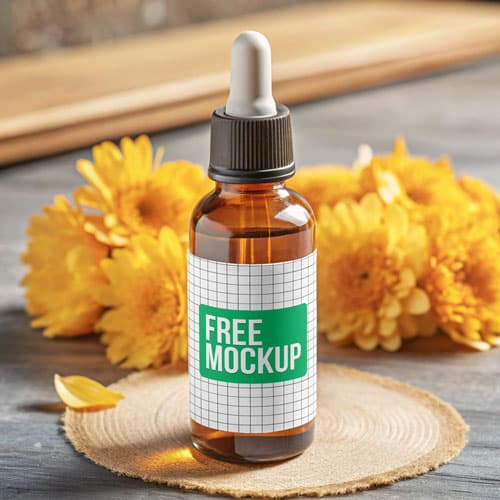 Free Amber Dropper Bottle PSD Mockup — Yellow Flowers & Rustic Coaster