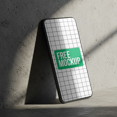 Free Smartphone PSD Mockup Leaning on Concrete — Gritty Tech